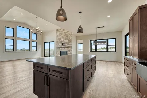 a kitchen with stainless steel appliances granite countertop counter space a sink refrigerator and window