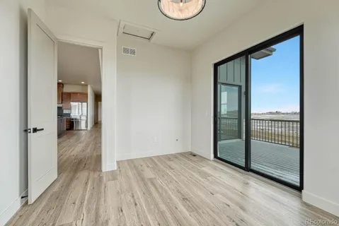 a view of hallway with wooden floor