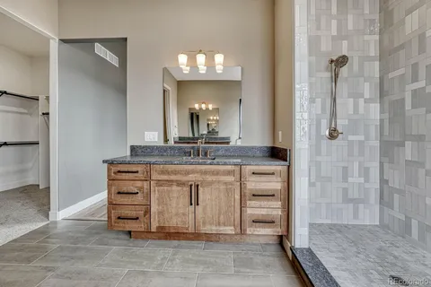 a bathroom with a double vanity sink and a mirror