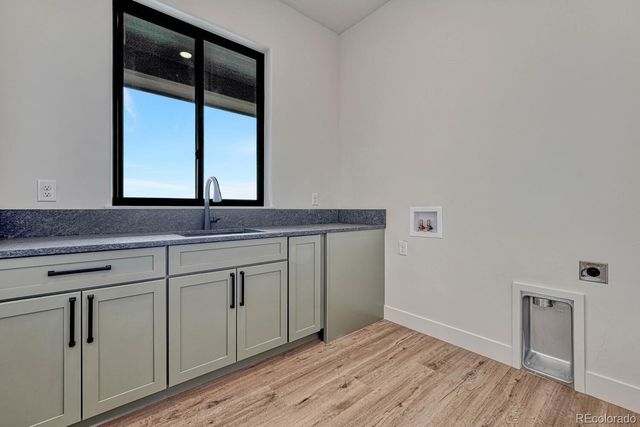 a view of a sink cabinets and wooden floor