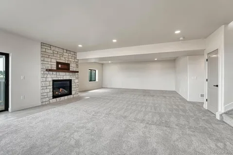 a view of an empty room with a fireplace