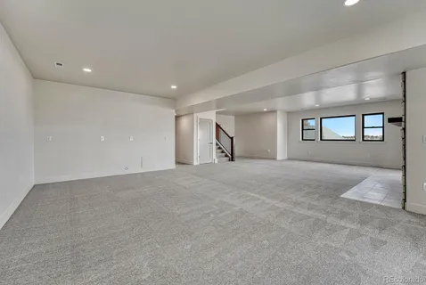 a bathroom with a toilet sink vanity and mirror