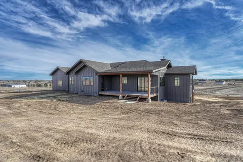 an aerial view of a house with swimming pool and glass doors