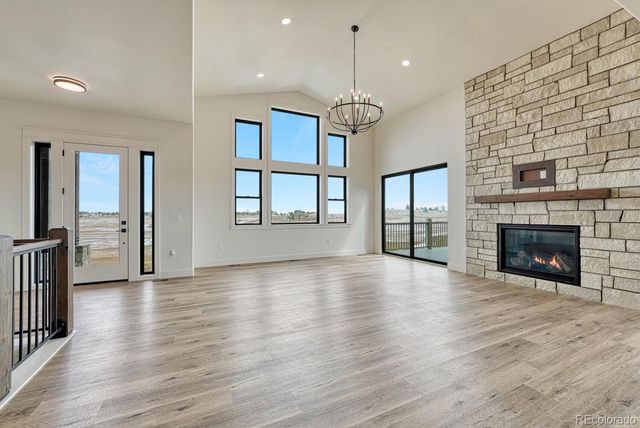 a view of empty room with wooden floor and fireplace
