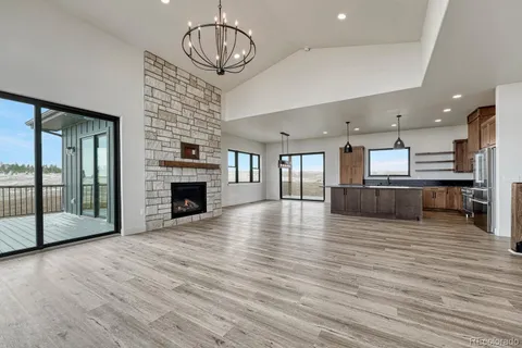 a view of a kitchen with a sink and an empty room
