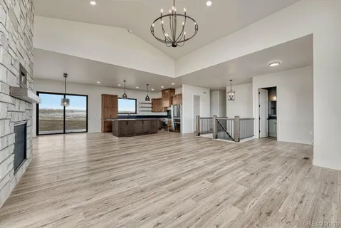 a view of a kitchen with a sink and a refrigerator