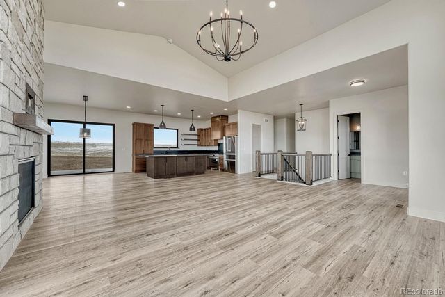 a view of a kitchen with a sink and a refrigerator