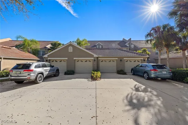 a view of a cars park in front of a building