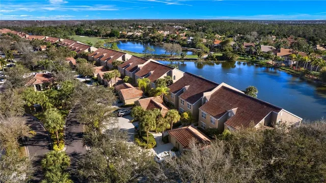 an aerial view of residential houses with outdoor space and swimming pool