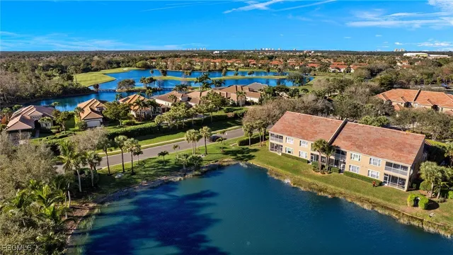 an aerial view of a houses with a lake view