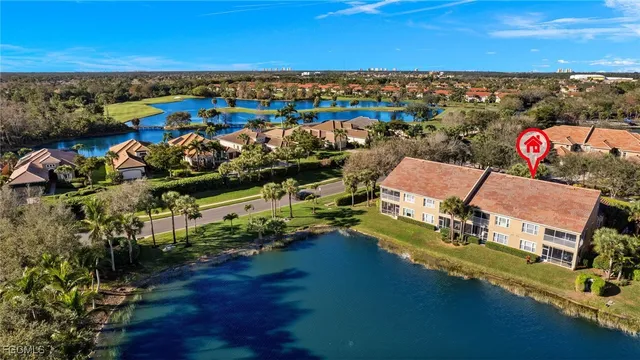an aerial view of a houses with a lake view