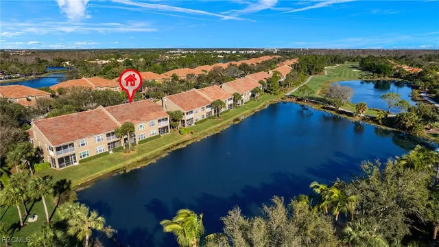 an aerial view of a house with a lake view