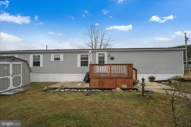 a backyard of a house with wooden deck