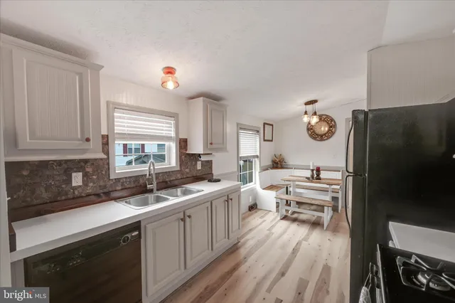 a kitchen with a sink and a refrigerator