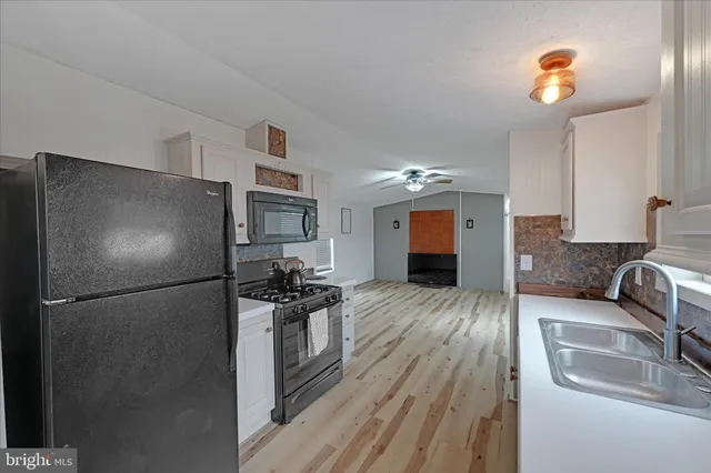 a kitchen with a refrigerator and a sink