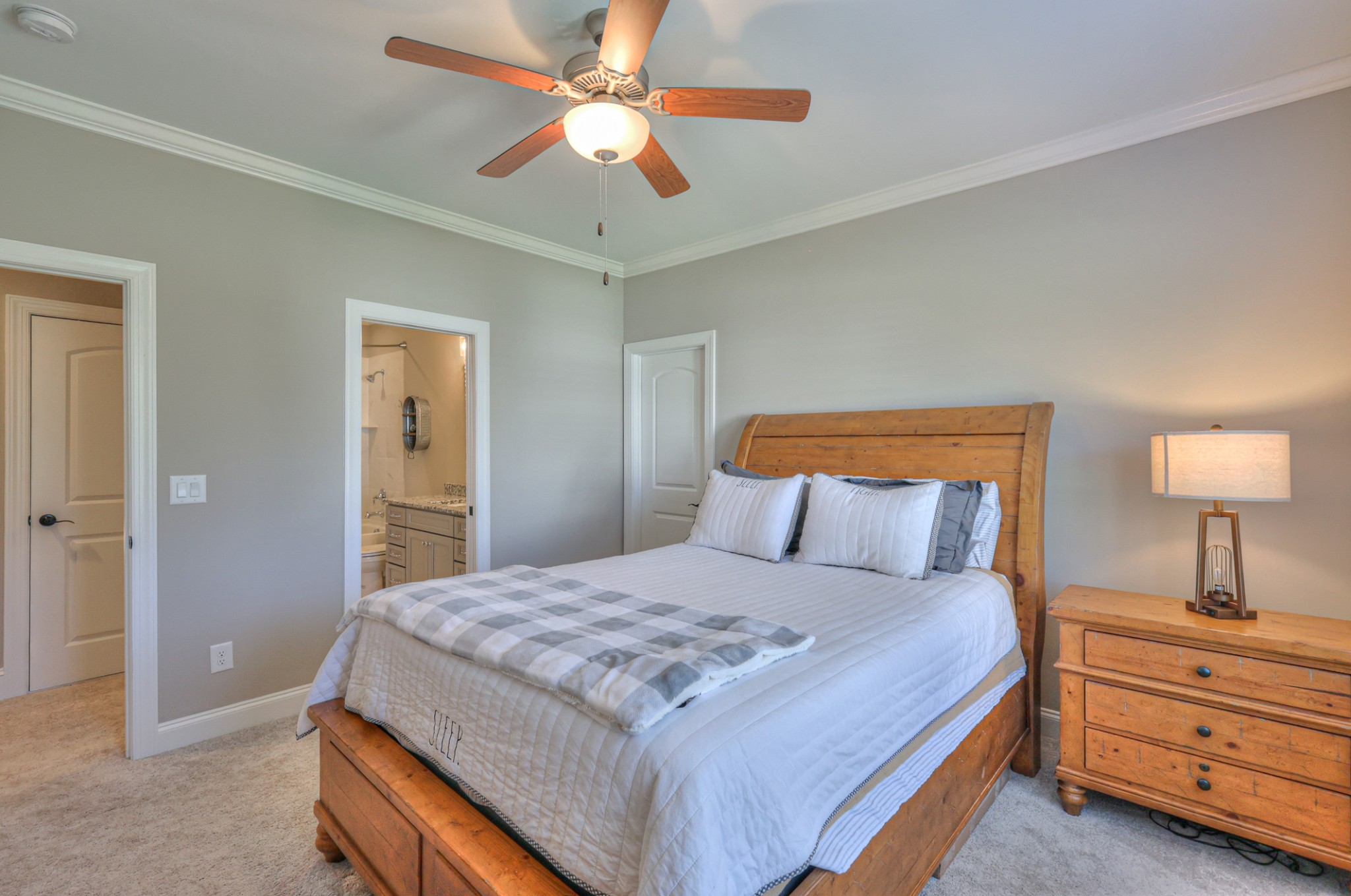8019 Burning Tree Farms Road Arrington, TN 37014 - Photo 26 of 47 a bedroom with a bed and a chandelier