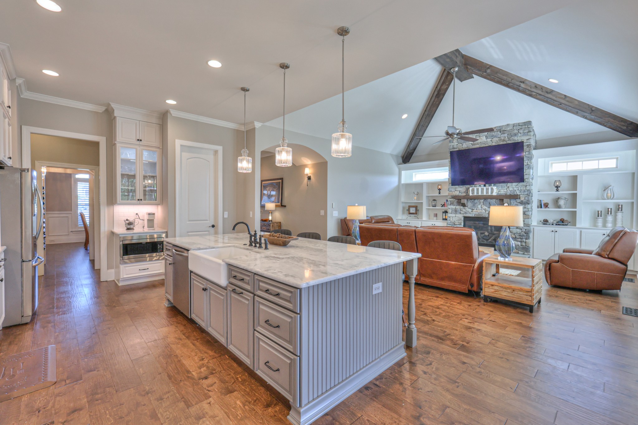 8019 Burning Tree Farms Road Arrington, TN 37014 - Photo 5 of 47 a large kitchen with stainless steel appliances a stove a sink dishwasher a living room with couches and kitchen view