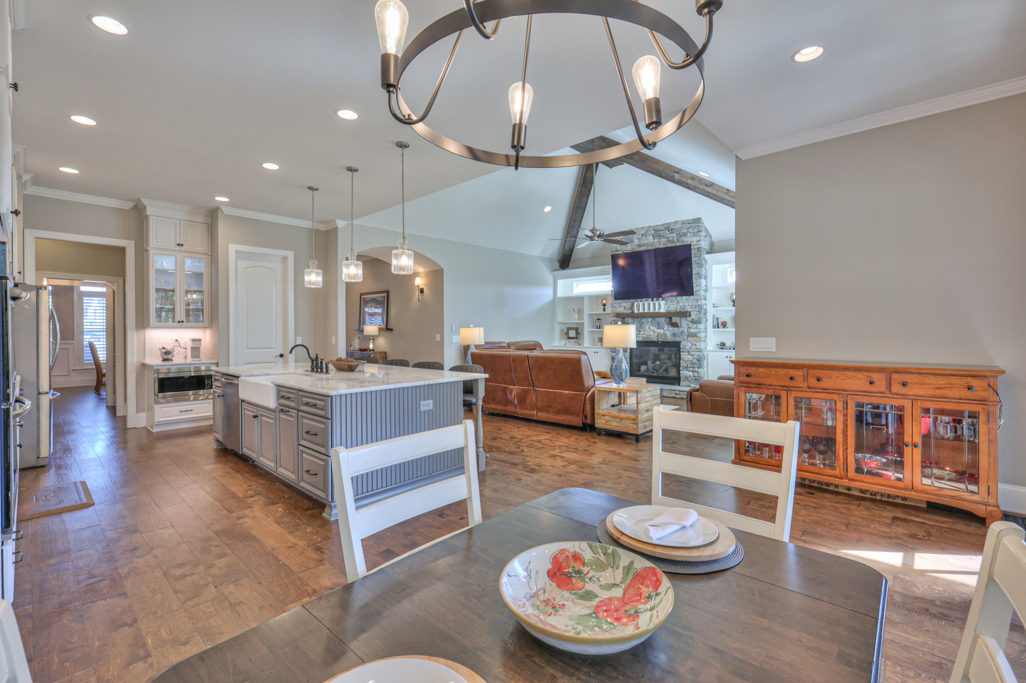 8019 Burning Tree Farms Road Arrington, TN 37014 - Photo 6 of 47 a large living room with stainless steel appliances kitchen island granite countertop a large kitchen island a stove and a view of living room