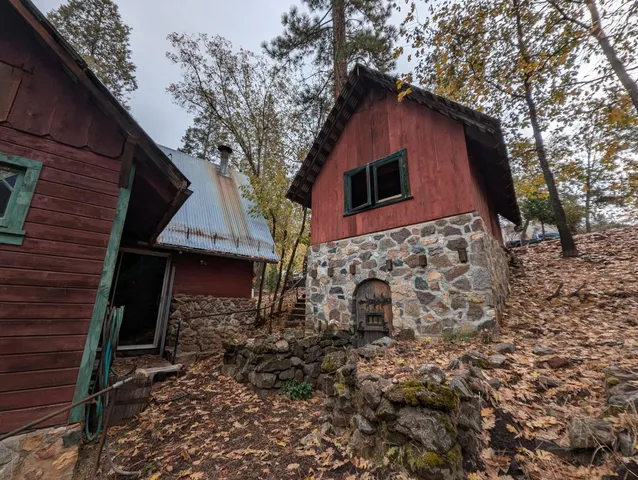 a red brick house with trees in front of it