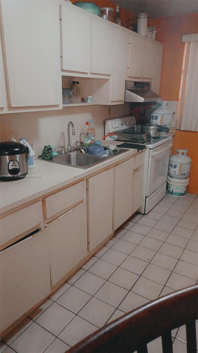 Flagami Miami, FL 33144 - Photo 4 of 6 a kitchen with stainless steel appliances a sink and cabinets