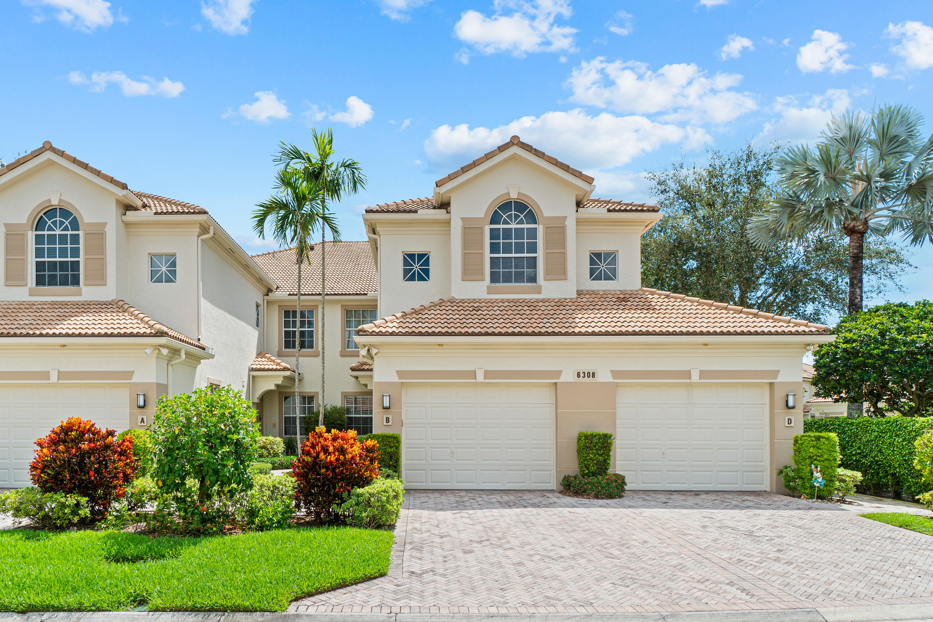6308 Graycliff Drive, Unit B Boca Raton, FL 33496 - Photo 2 of 29 a front view of a house with a yard and garage