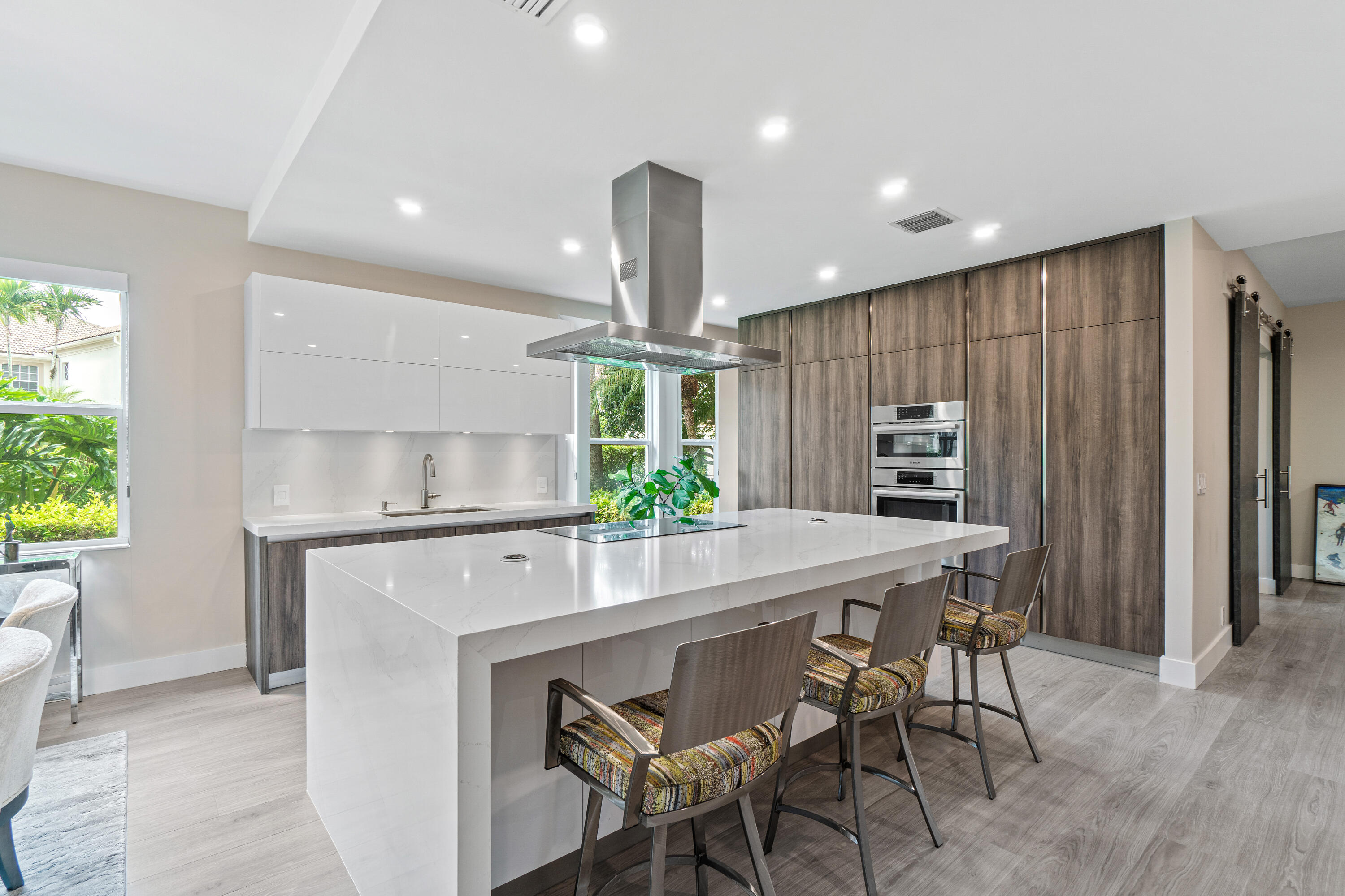6308 Graycliff Drive, Unit B Boca Raton, FL 33496 - Photo 5 of 29 a kitchen with stainless steel appliances kitchen island a table and chairs in it