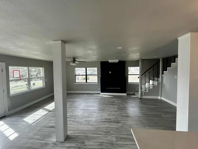 wooden floor in an empty room with a window
