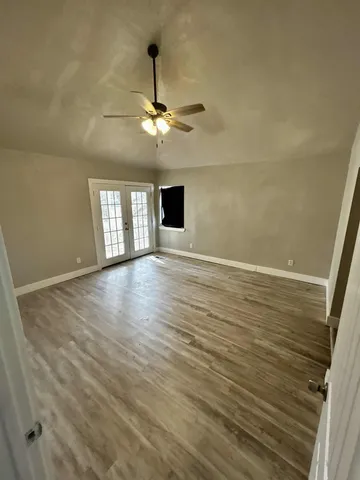 a bathroom with a granite countertop sink a toilet a mirror and bathtub