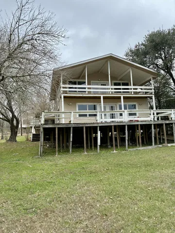 a view of a house with yard and sitting area