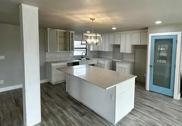 a kitchen that has a lot of cabinets in it