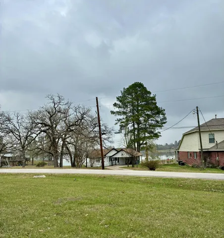 a view of a house with a wooden deck