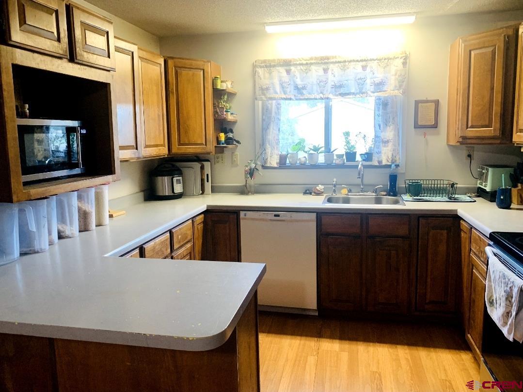 1128 Montana Way Nucla, CO 81424 - Photo 15 of 30 a kitchen with a sink a window and cabinets