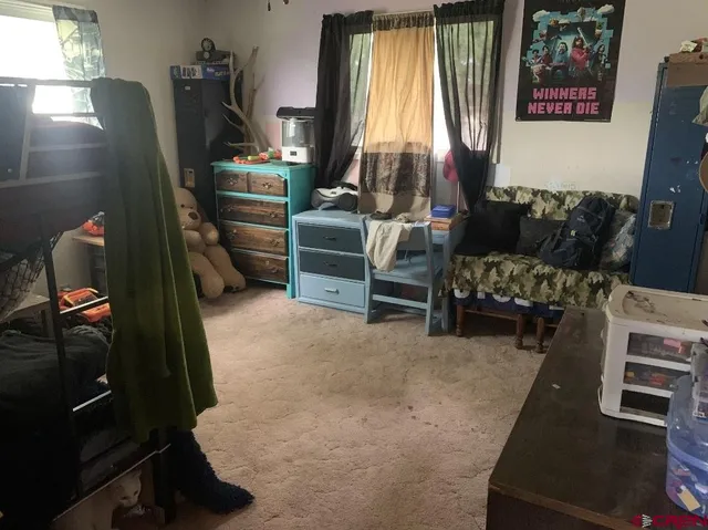 a living room with furniture a large window and a flat screen tv