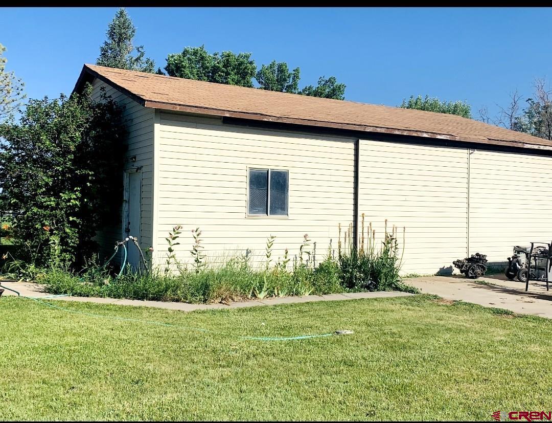 1128 Montana Way Nucla, CO 81424 - Photo 2 of 30 a view of a backyard with plants and a barbeque grill