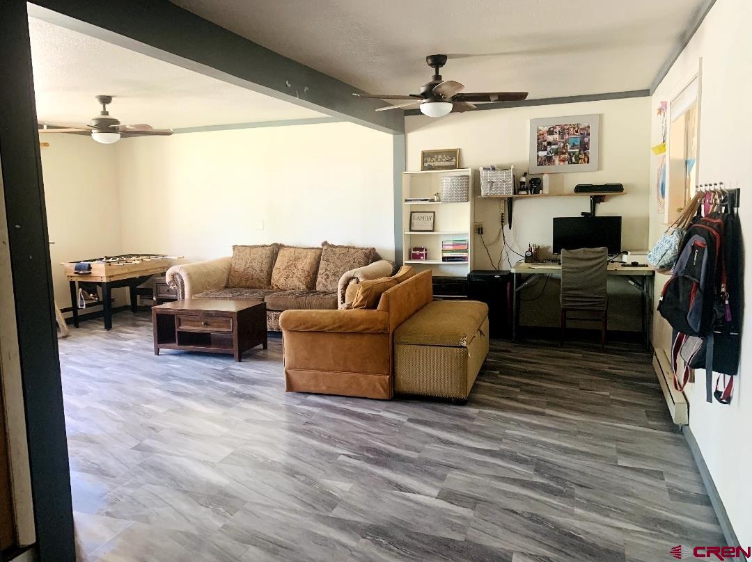 1128 Montana Way Nucla, CO 81424 - Photo 21 of 30 a living room with furniture a large window and a flat screen tv