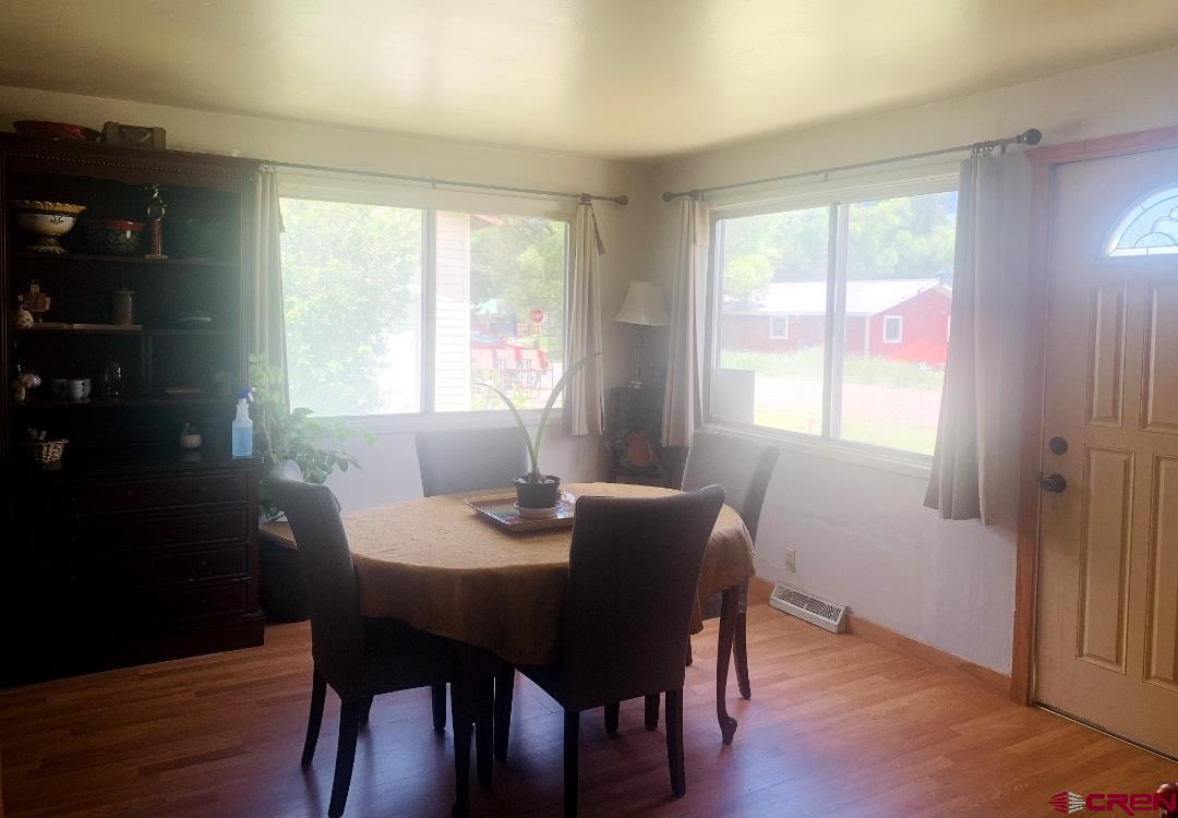 1128 Montana Way Nucla, CO 81424 - Photo 24 of 30 a view of a dining room with furniture window and wooden floor