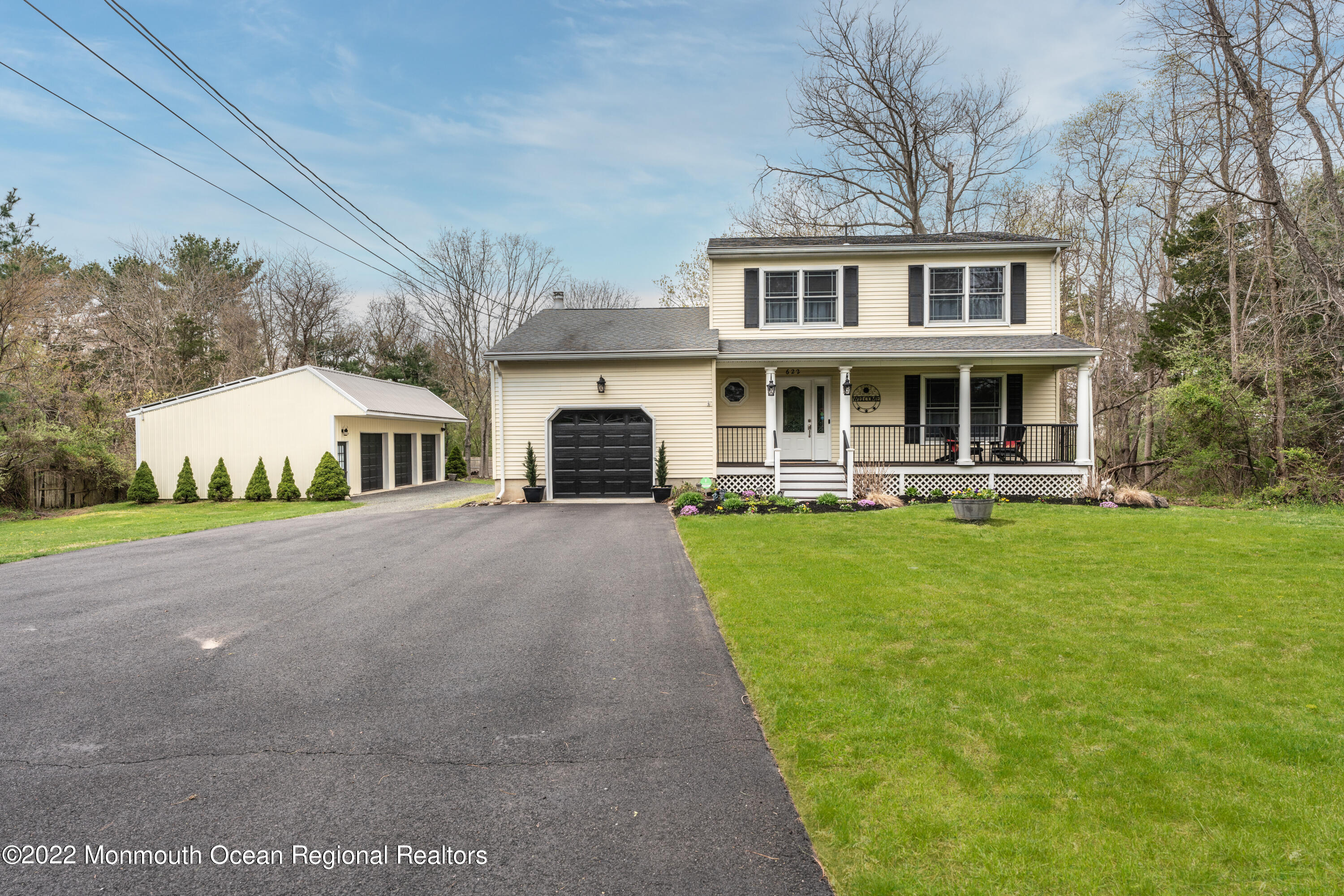 622 Harmony Road Jackson, NJ 08527 - Photo 2 of 24 a front view of a house with a yard table and chairs
