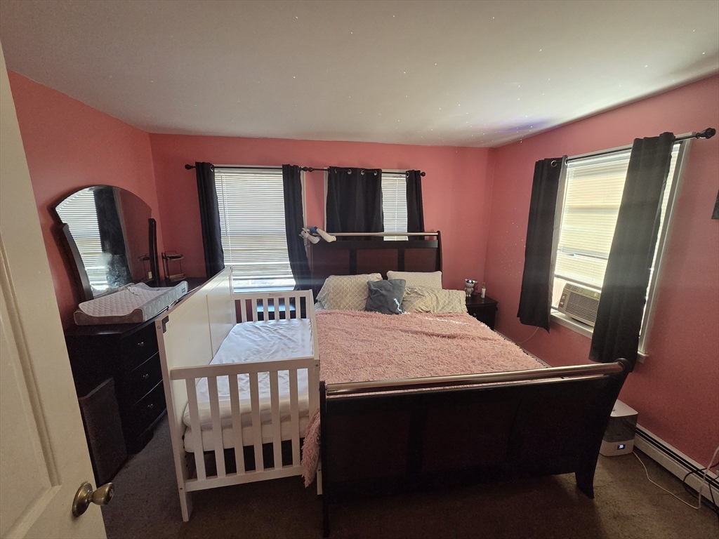 32 Crowell Street Boston, MA 02124 - Photo 13 of 18 a bed sitting in a bedroom next to a window