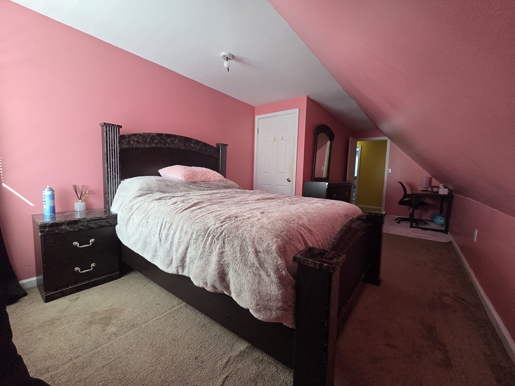 32 Crowell Street Boston, MA 02124 - Photo 15 of 18 a spacious bedroom with a bed and a dresser