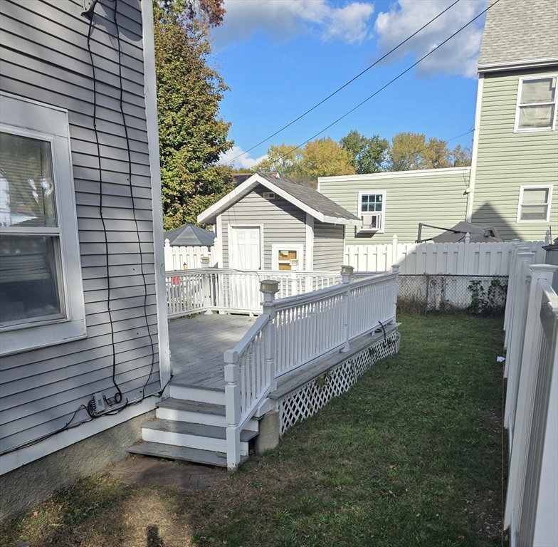 32 Crowell Street Boston, MA 02124 - Photo 2 of 18 a view of a house with a small yard and wooden fence