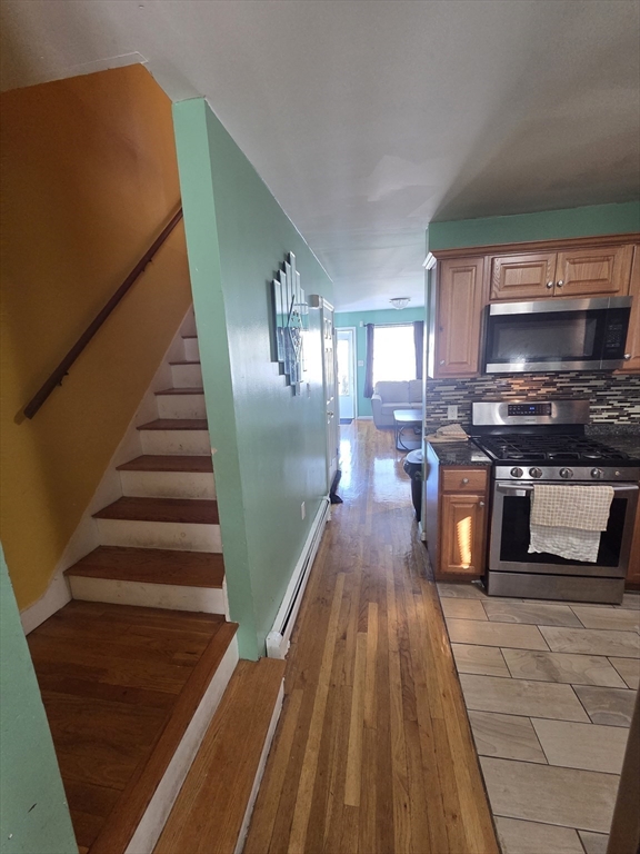 32 Crowell Street Boston, MA 02124 - Photo 6 of 18 a kitchen with wooden floors and a sink