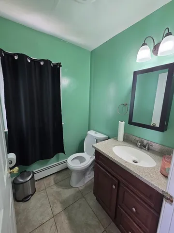 a bathroom with a sink a toilet and mirror