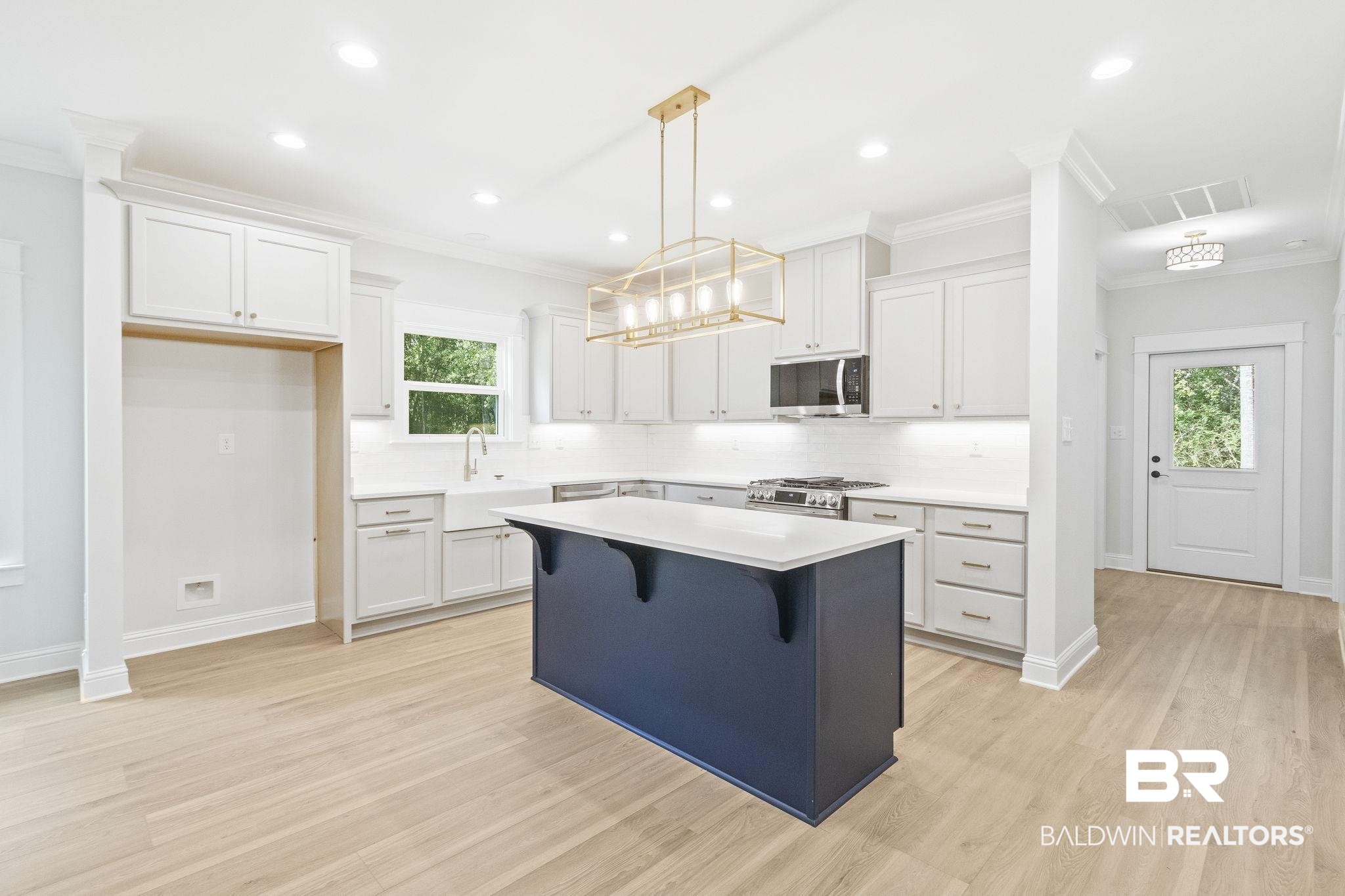 12130 Reunion Place Foley, AL 36535 - Photo 11 of 42 Kitchen with a wealth of natural light, a kitchen island, appliances with stainless steel finishes, and light hardwood / wood-style floors