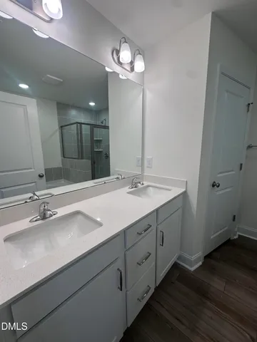 a bathroom with a double vanity sink and a mirror