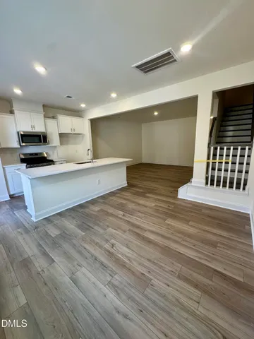 a view of kitchen with kitchen island microwave and stove