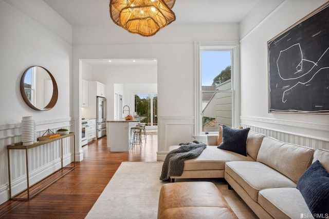 a living room with furniture and a mirror
