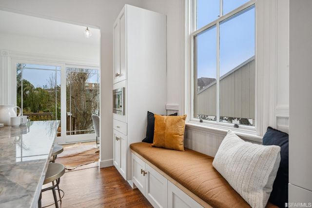 a large kitchen with stainless steel appliances granite countertop a lot of counter space and wooden floor