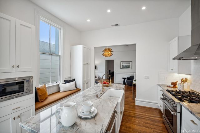 a view of a kitchen with a refrigerator and washer