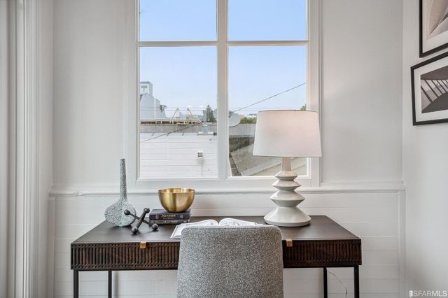 a bathroom with a granite countertop sink a potted plant and a shower