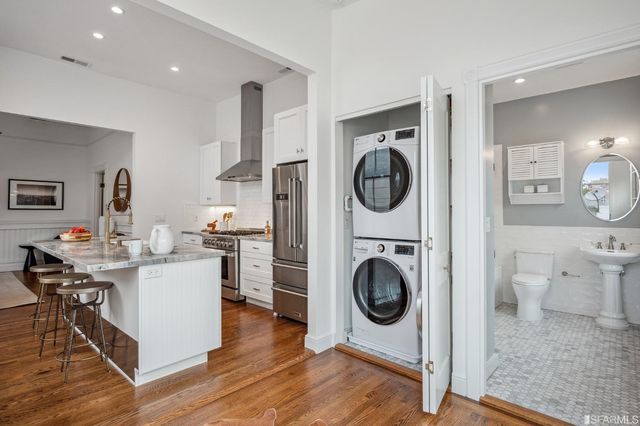 a bathroom with a granite countertop sink a mirror and a shower